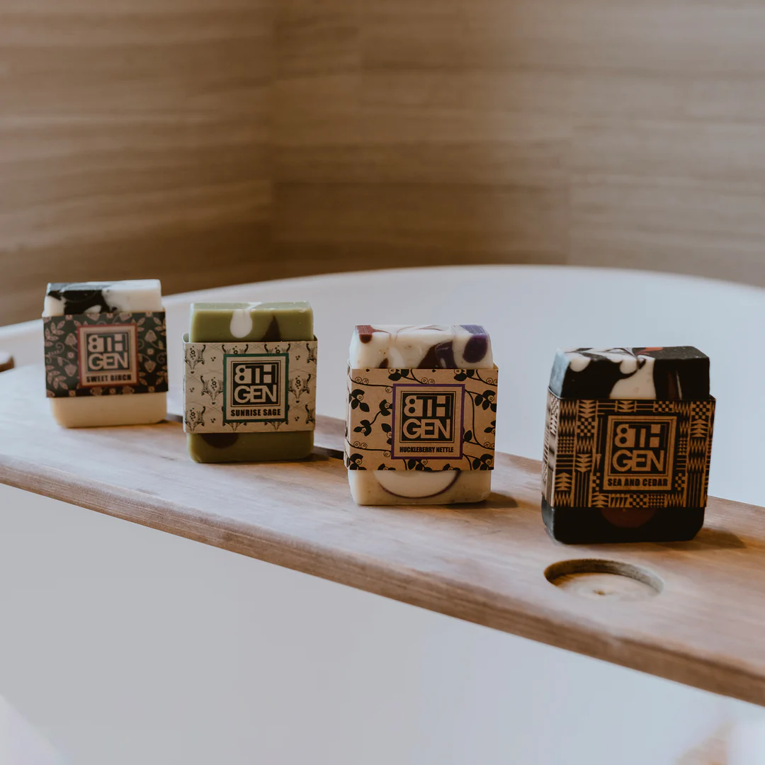 photo of four wrapped bars of soap sitting on a wood slab