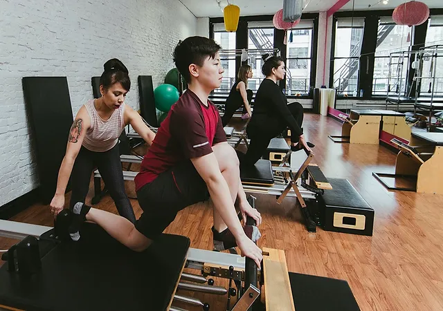 Bodytonic Pilates owner Nadia Rodriguez guiding a classmember