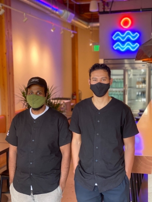 Chef Rome and Owner Vic standing side by side.