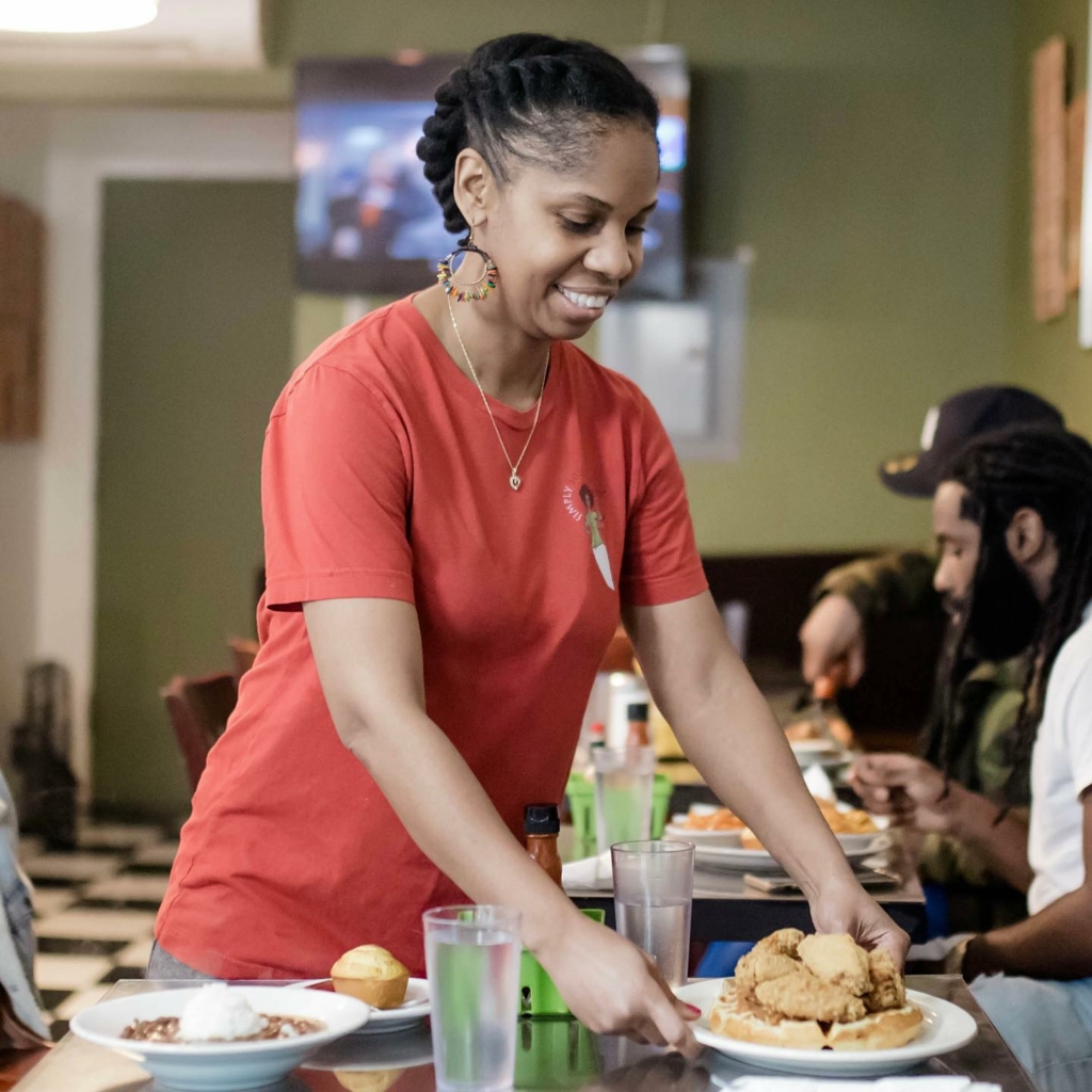 Lillian serving food at Simply Soulful