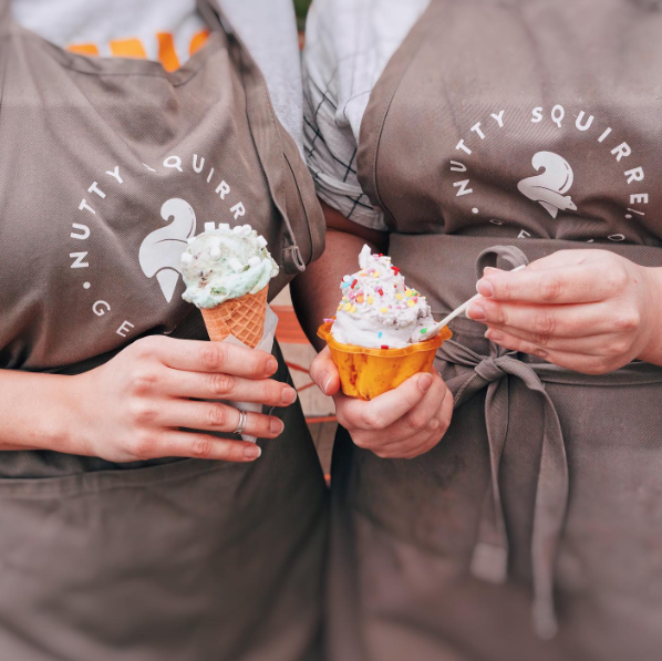 Staff holding ice cream at Nutty Squirrel Gelato
