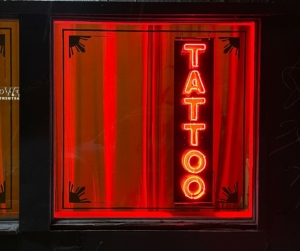 Neon signage outside tattoo parlor