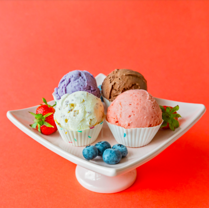 A cake plate with scoops of ice cream placed in cupcake liners