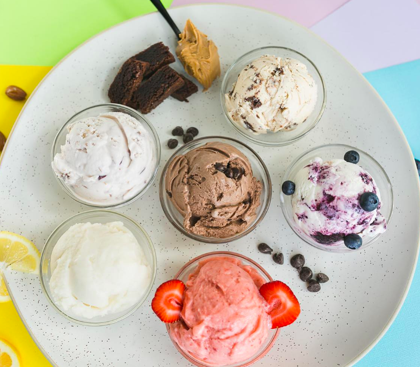 Scoops of ice cream in small bowls displayed on a plate