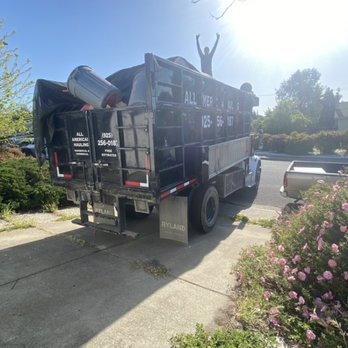 GSC-Hauling-Junk-Removal-worker-on-top-of-filled-truck