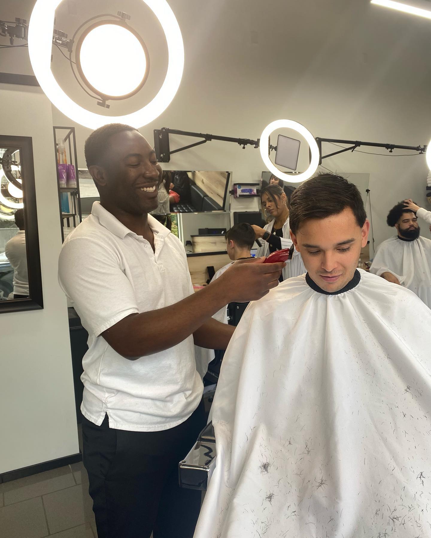 Rain City Barbershop owner Percy cutting a clients hair